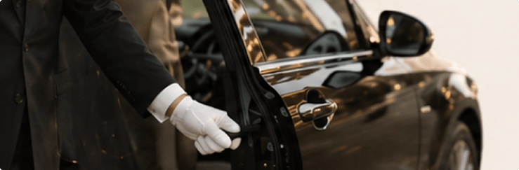 Urban Butler concierge opening a luxury car door in white gloves